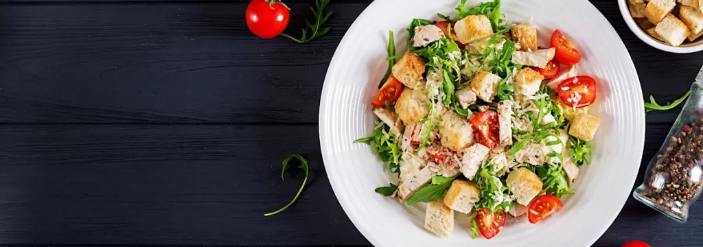 Delicious chicken salad with croutons and tomatoes.